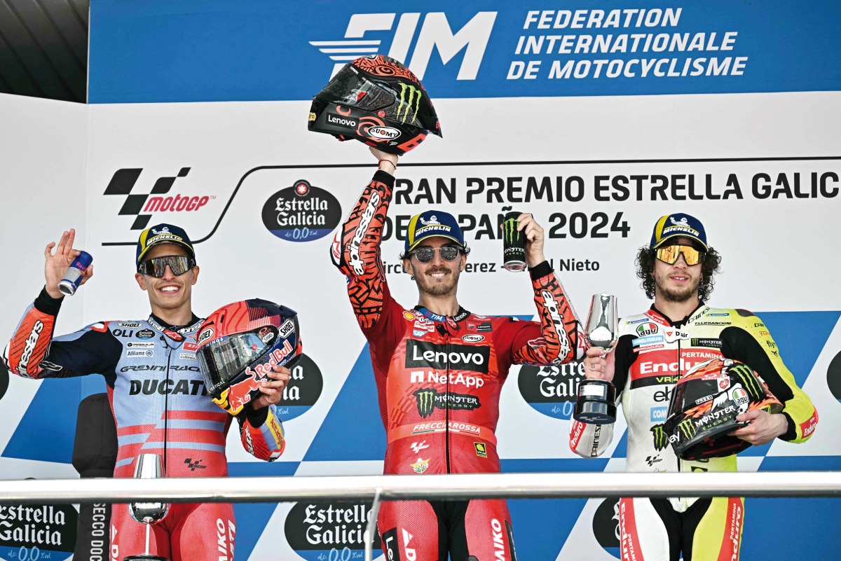 FROM LEFT: Second-placed Marc Marquez, winner Francesco Bagnaia and third-placed Marco Bezzecchi celebrate on the podium yesterday. Photo by AFP. 