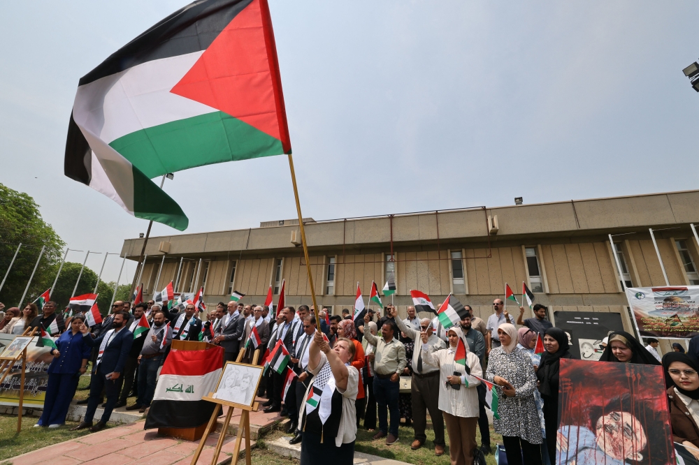 Iraqi university students and professors carrying Palestinian flags rally at Al-Nahrain University in Baghdad on May 2, 2024 in solidarity with Gaza and pro-Palestinian protests at US universities. Photo by AHMAD AL-RUBAYE / AFP.