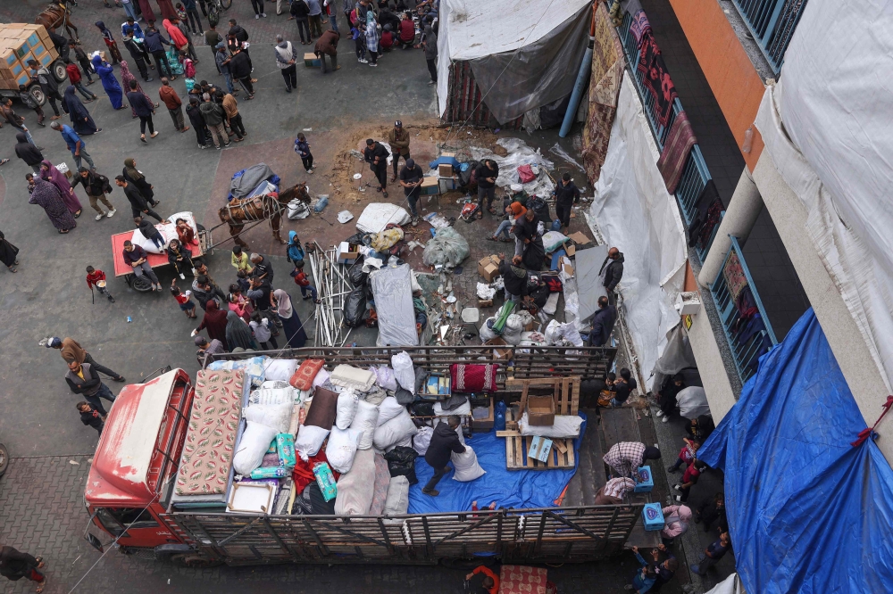 Displaced Palestinians in Rafah in the southern Gaza Strip pack their belongings on May 6, 2024. (Photo by AFP)