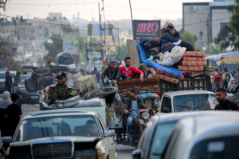 Displaced Palestinians flee Rafah with their belongings to safer areas in the southern Gaza Strip on May 7, 2024. (Photo by AFP)