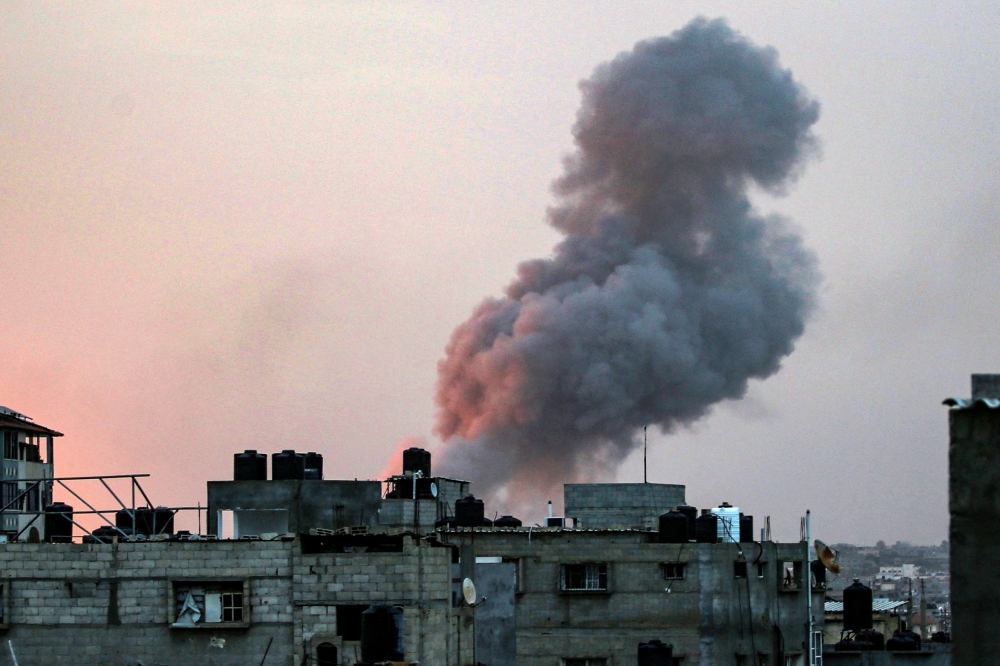 Smoke rises above buildings during an early morning Israeli strike on Rafah in the southern Gaza Strip on May 11, 2023. (Photo by AFP)