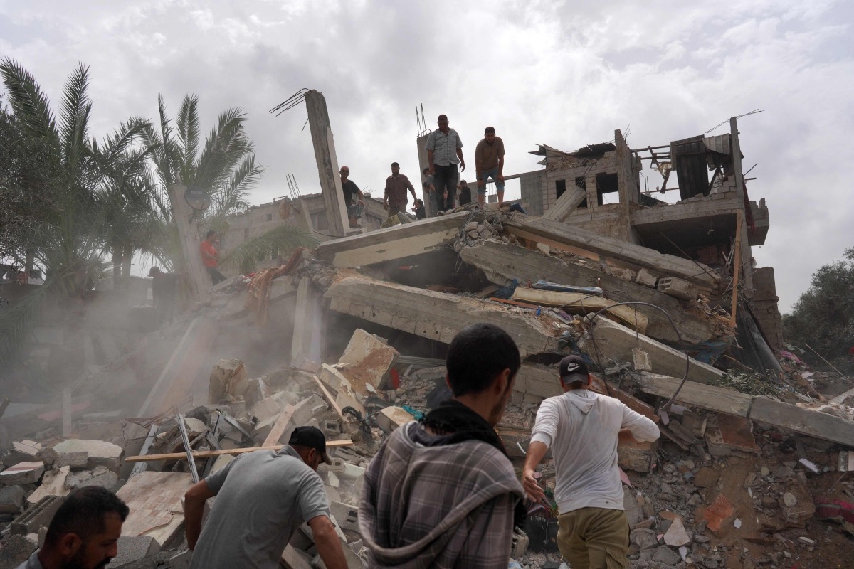 Palestinians check the rubble of a residential building destroyed in an Israeli strike in Al-Zawayda in the central Gaza Strip on May 11, 2024. (Photo by AFP)