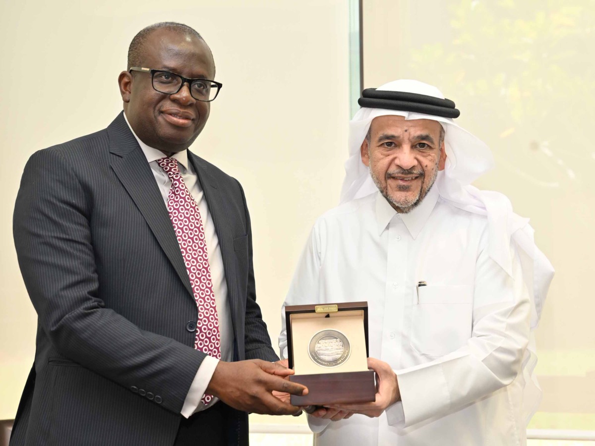 QU President Dr. Omar Al Ansari (right) during the signing of the agreement with one of the officials. 