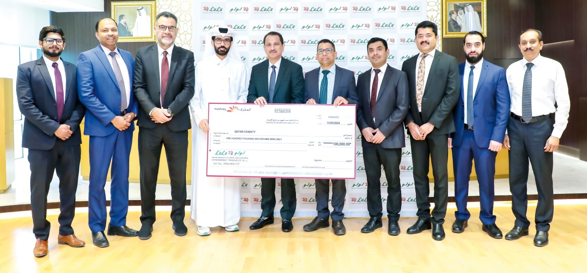 Director of the Resource Development Department at Qatar Charity Ali Al-Ghareeb receiving a donation cheque from Regional Director of Lulu Hypermarket Qatar Shaijan MO.