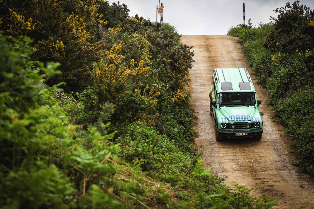 An Ineos hydrogen fuelled Grenadier car is driven off-road on a test track during a 