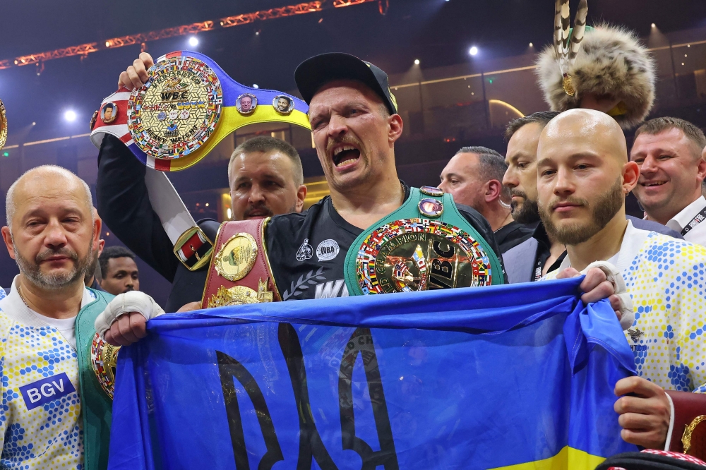 Ukraine's Oleksandr Usyk (C) celebrates his victory over Britain's Tyson Fury at Kingdom Arena in Riyadh, Saudi Arabia on May 19, 2024. (Photo by Fayez Nureldine / AFP)