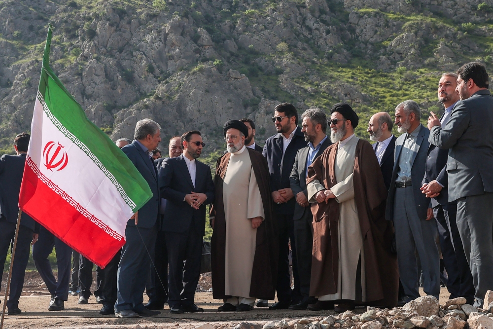 A handout picture provided by the Iranian presidency shows Iran's President Ebrahim Raisi (C) at the site of Qiz Qalasi, the third dam jointly built by Iran and Azerbaijan on the Aras River, ahead of its inauguration ceremony on May 19, 2024. Photo by Iranian Presidency / AFP