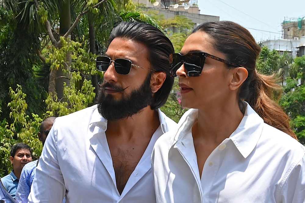 Bollywood actors Ranveer Singh (left) and his wife Deepika Padukone arrive to cast their ballots at a polling station during the fifth phase of voting in India's general election, in Mumbai on May 20, 2024. (Photo by Sujit Jaiswal / AFP)