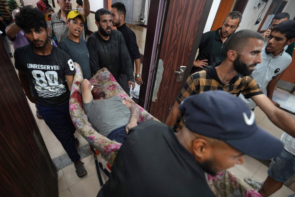 Injured Palestinians are transported to the Al-Aqsa Martyrs Hospital in Deir al-Balah following Israeli bombardment of al-Bureij in the eastern Gaza Strip on May 21, 2024. Photo by AFP