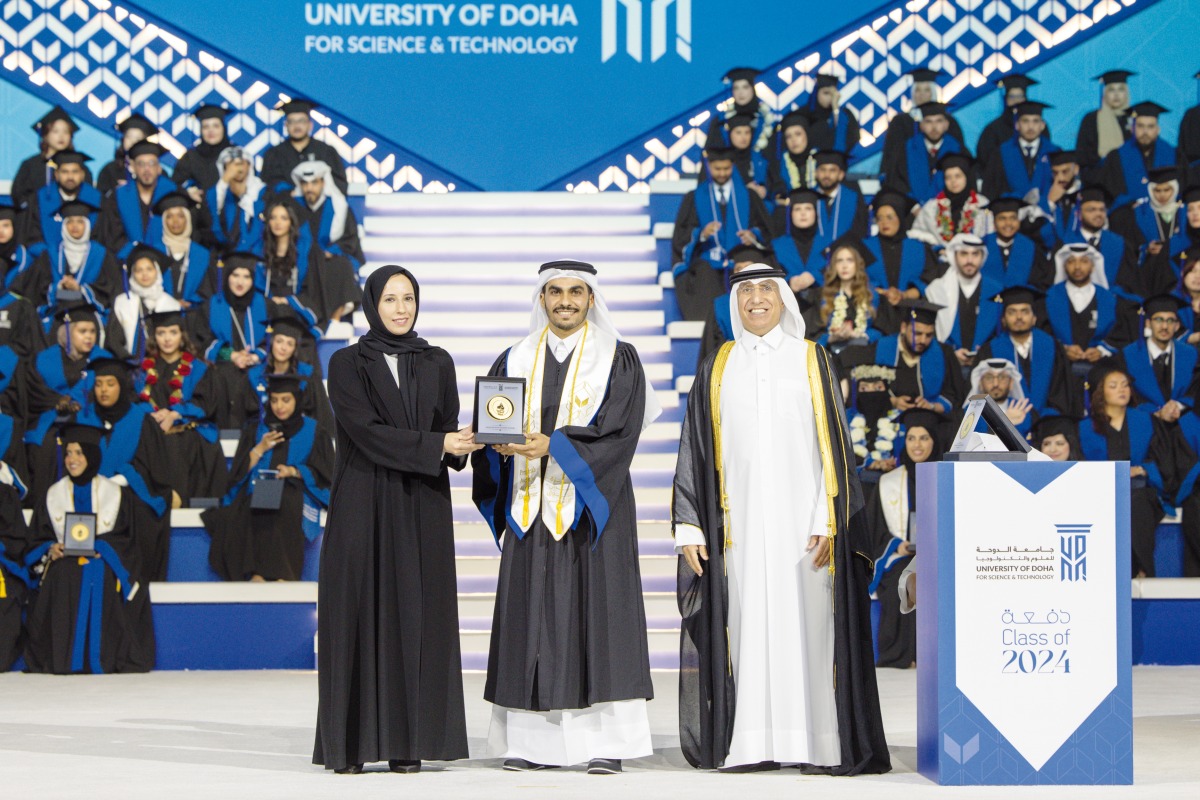 Minister of Education and Higher Education H E Buthaina bint Ali Al Jabr Al Nuaimi honouring a graduate. President of UDST Dr. Salem Al Naemi is also seen.