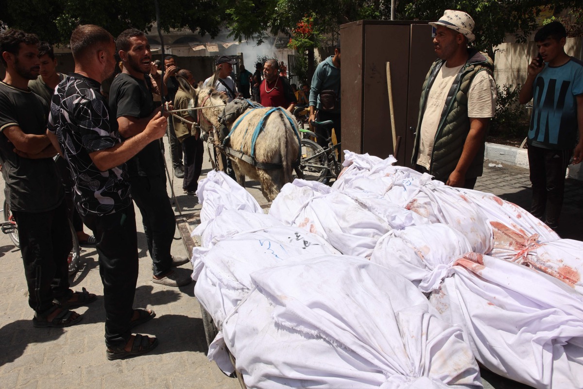 Palestinians transport the bodies of gazans killed in an Israeli strike to a clinic in gaza City on May 25, 2024. (Photo by Omar AL-QATTAA / AFP)
