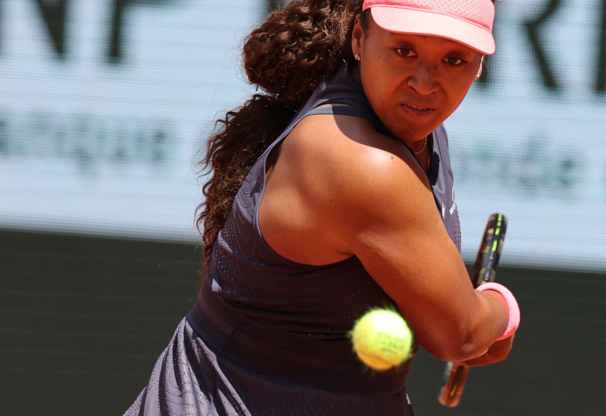 Japan's Naomi Osaka eyes the ball as she plays against Italy's Lucia Bronzetti during their women's singles match on day one of The French Open tennis tournament on Court Philippe-Chatrier at The Roland Garros Complex in Paris on May 26, 2024. (Photo by Alain JOCARD / AFP)