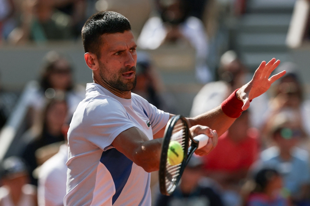 Serbia's Novak Djokovic takes part in a practice session during the French Open tennis tournament on Court Philippe-Chatrier at the Roland Garros Complex in Paris on May 25, 2024. (Photo by ALAIN JOCARD / AFP)