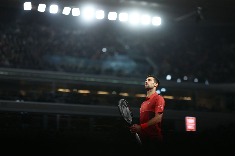 Serbia's Novak Djokovic reacts as he plays against Italy's Lorenzo Musetti during their men's singles match on Court Philippe-Chatrier on June 1, 2024. (Photo by Emmanuel Dunand / AFP)
 