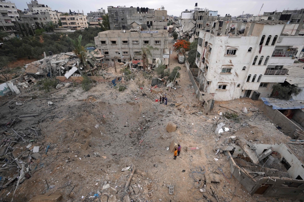 Palestinians inspect the damage after an Israeli strike in Nuseirat, in the central Gaza Strip, on June 3, 2024. (Photo by Bashar Taleb / AFP)
