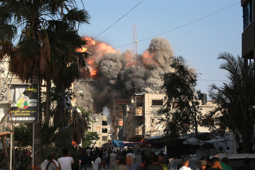 A ball of fire and black smoke rises moments after an Israeli air strike targeted a residential building in the city of Bureij in the central Gaza Strip on June 3, 2024. (Photo by Bashar Taleb / AFP)

