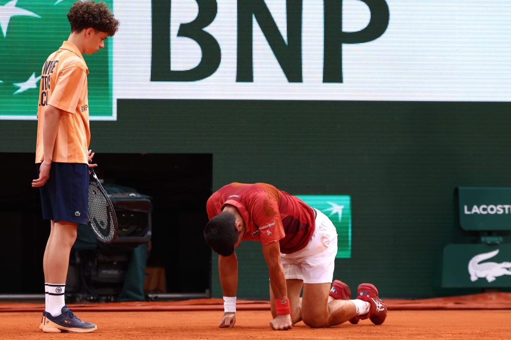 Serbia's Novak Djokovic reacts after falling on the court during his men's singles round of sixteen match against Argentina's Francisco Cerundolo on Court Philippe-Chatrier on day nine of the French Open tennis tournament at the Roland Garros Complex in Paris on June 3, 2024. Photo by Emmanuel Dunand / AFP.
 