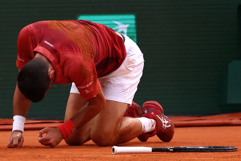 Serbia's Novak Djokovic reacts after falling on the court during his men's singles round of sixteen match against Argentina's Francisco Cerundolo on Court Philippe-Chatrier on day nine of the French Open tennis tournament at the Roland Garros Complex in Paris on June 3, 2024. (Photo by Emmanuel Dunand / AFP)