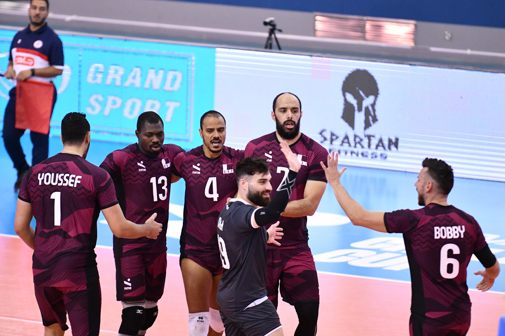 Qatar players celebrate after scoring a point against China.