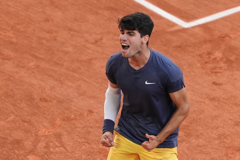 Spain's Carlos Alcaraz celebrates after winning against Germany's Alexander Zverev at the end of their men's singles final match on Court Philippe-Chatrier on day fifteen of the French Open tennis tournament at the Roland Garros Complex in Paris on June 9, 2024. (Photo by Dimitar DILKOFF / AFP)