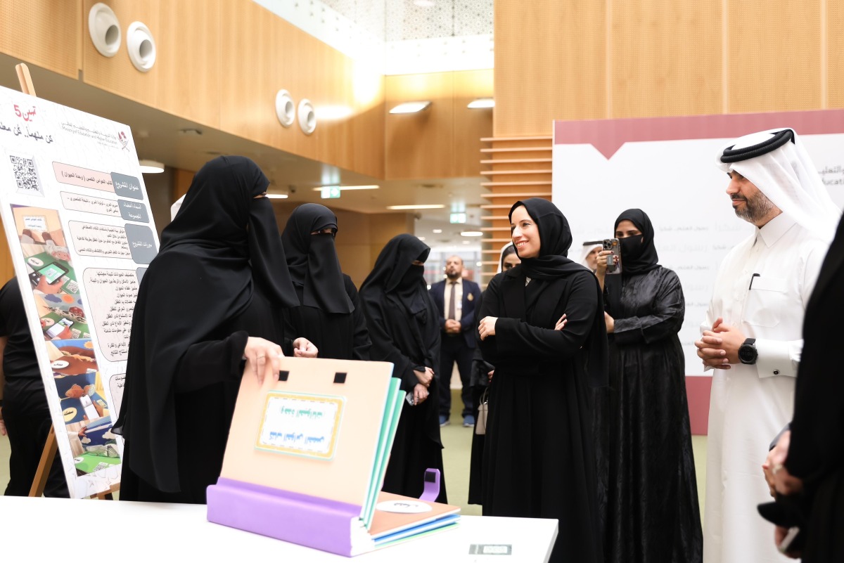 Minister of Education and Higher Education H E  Buthaina bint Ali Al Jabr Al Nuaimi with officials and the graduates during the graduation ceremony.