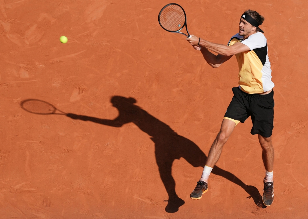 Germany's Alexander Zverev plays a backhand return to Spain's Carlos Alcaraz during their men's singles final match on Court Philippe-Chatrier on day fifteen of the French Open tennis tournament at the Roland Garros Complex in Paris on June 9, 2024. (Photo by Dimitar DILKOFF / AFP)