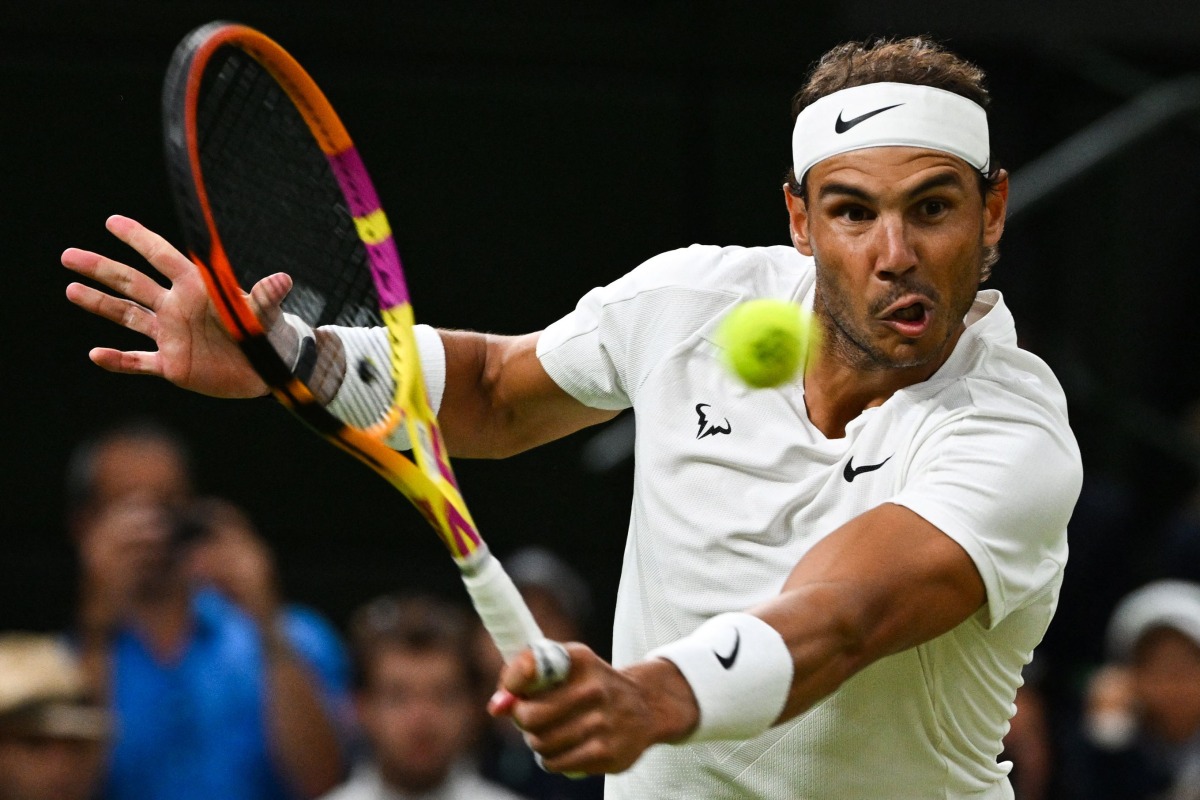 File:  Spain's Rafael Nadal returns the ball to Italy's Lorenzo Sonego during their men's singles tennis match on the sixth day of the 2022 Wimbledon Championships at The All England Tennis Club in Wimbledon, southwest London, on July 2, 2022.(Photo by SEBASTIEN BOZON / AFP)