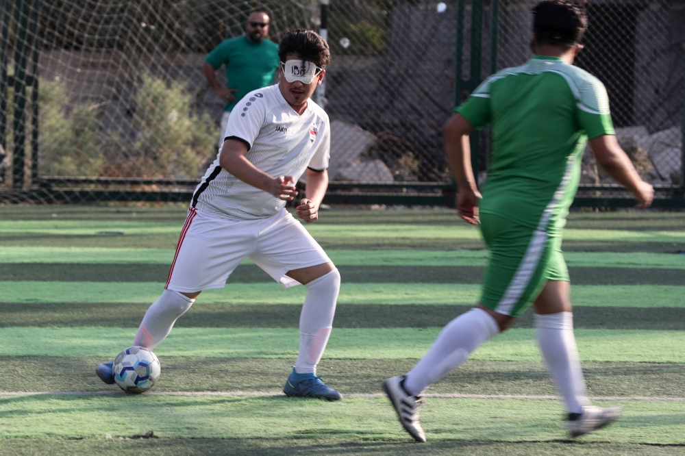 Members of Iraq's first national football team for the visually impaired, train at a sports club in Baghdad on May 22, 2024. (Photo by Ahmad Al-Rubaye / AFP)