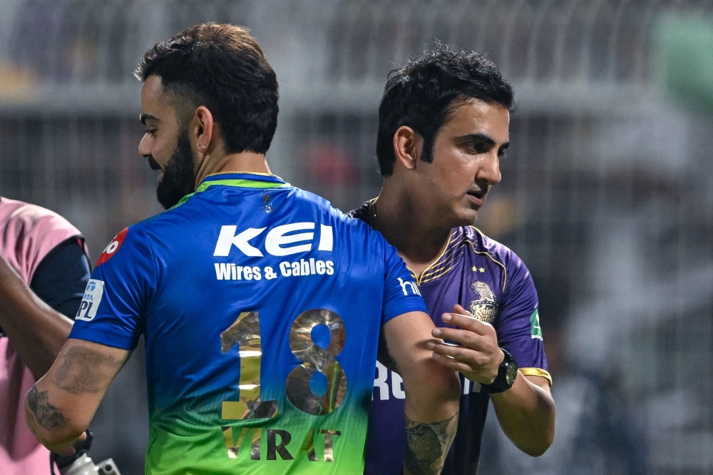 (Files) Royal Challengers Bengaluru's player Virat Kohli and Kolkata Knight Riders' mentor Gautam Gambhir (R) greet each other at the end of the Indian Premier League (IPL) Twenty20 cricket match between Kolkata Knight Riders and Royal Challengers Bengaluru at the Eden Gardens in Kolkata on April 21, 2024. (Photo by Dibyangshu Sarkar / AFP) 
