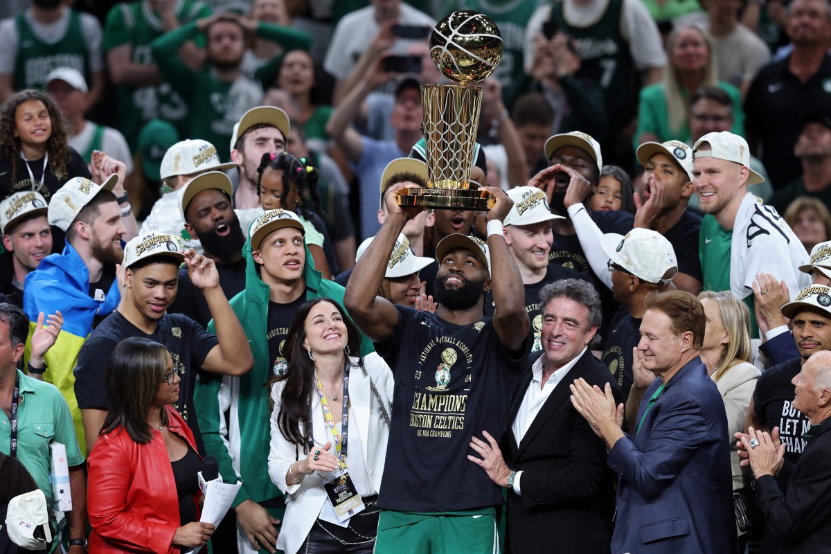 Jaylen Brown of the Boston Celtics holds up the Larry O'Brien trophy after Boston's 106-88 win against the Dallas Mavericks in Game Five of the 2024 NBA Finals at TD Garden on June 17, 2024 in Boston, Massachusetts.(Photo by Adam Glanzman / GETTY IMAGES NORTH AMERICA / Getty Images via AFP)