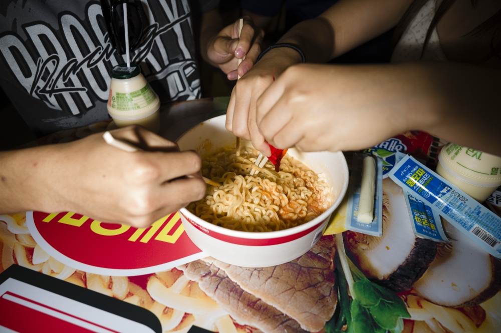 Tourists prepare Buldak ramyeon - South Korea's famed 