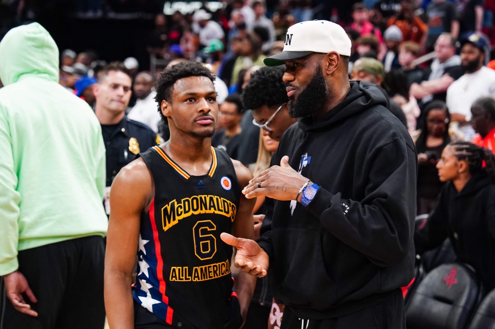 (FILES) Bronny James #6 of the West team talks to Lebron James of the Los Angeles Lakers after the 2023 McDonald's High School Boys All-American Game at Toyota Center on March 28, 2023 in Houston, Texas. (Photo by Alex Bierens de Haan / GETTY IMAGES NORTH AMERICA / AFP)
