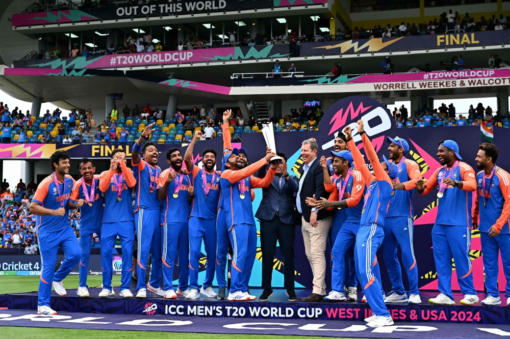 :Team India celebrates with the trophy after winning the ICC men's Twenty20 World Cup 2024 final cricket match between India and South Africa at Kensington Oval in Bridgetown, Barbados, on June 29, 2024. (Photo by CHANDAN KHANNA / AFP)
