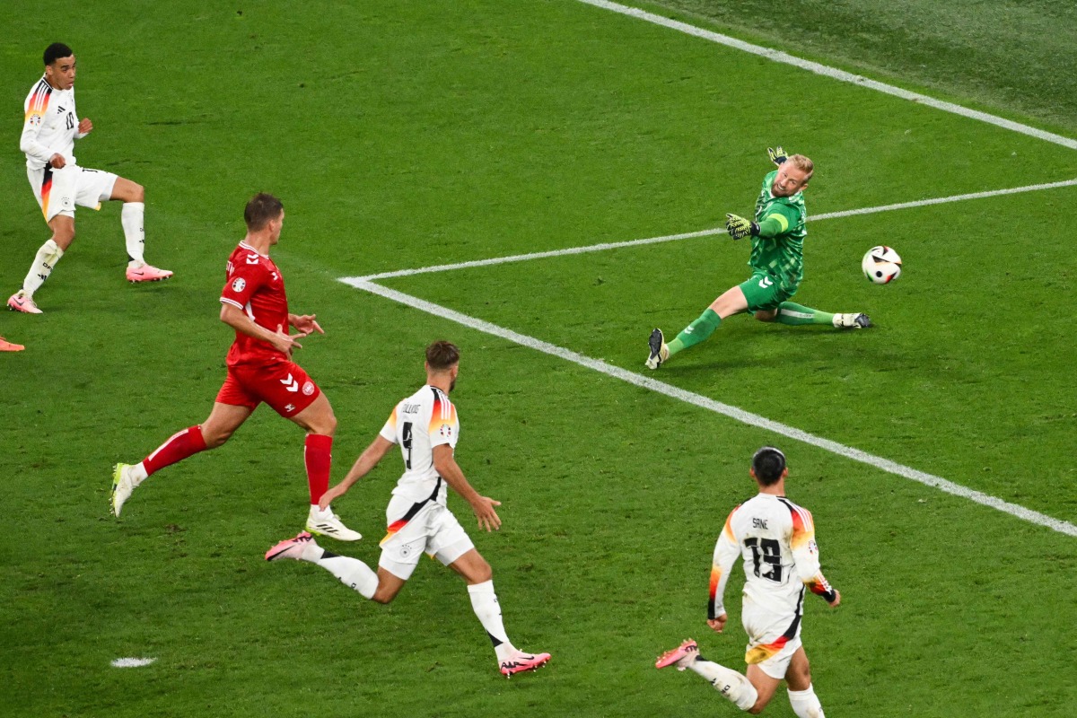 Germany’s Jamal Musiala (left) scores his team’s second goal past Denmark’s goalkeeper Kasper Schmeichel. AFP