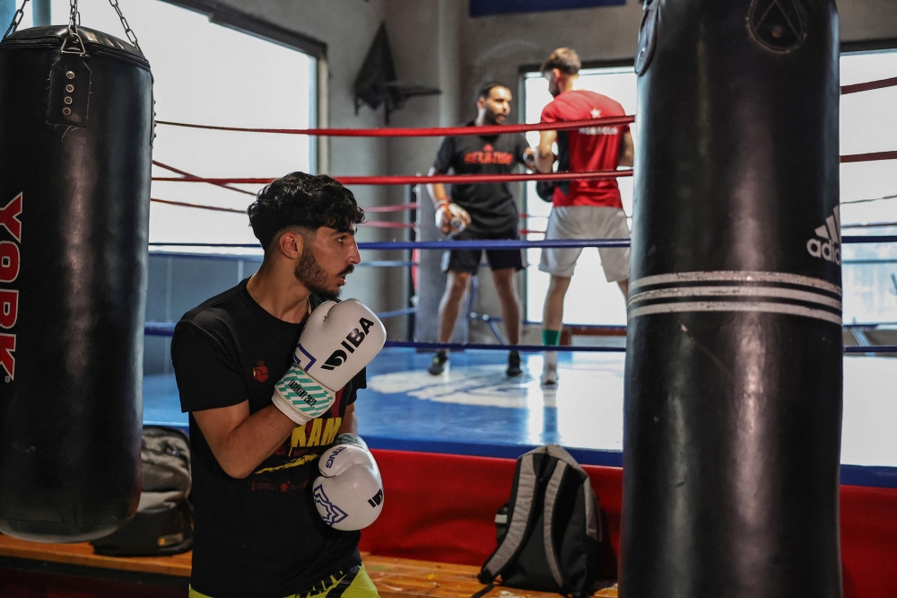 A picture taken on June 22, 2024 shows Palestinian lightweight boxer Waseem Abu Sal training at a gym in Ramallah city in the occupied West Bank, as part of his preparations after qualifying for the upcoming 2024 Paris Olympic games. (Photo by Zain JAAFAR / AFP)
