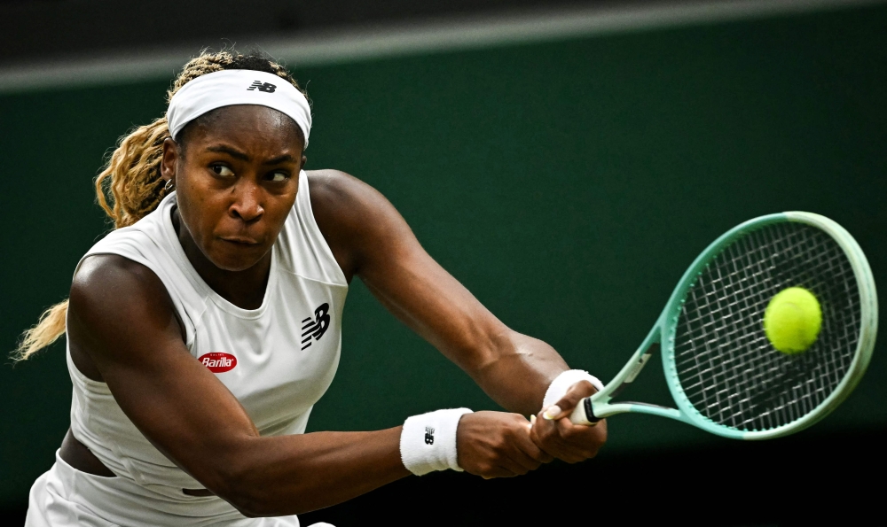 US player Coco Gauff returns the ball to Britain's Sonay Kartal during their women's singles tennis match on the fifth day of the 2024 Wimbledon Championships at The All England Lawn Tennis and Croquet Club in Wimbledon, southwest London, on July 5, 2024. (Photo by Ben Stansall / AFP) 