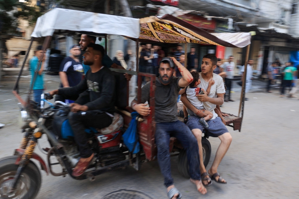 A tuktuk driver rushes to transport casualties after Israeli bombardment at al-Bureij refugee camp in the central Gaza Strip on July 8, 2024. (Photo by Eyad Baba / AFP)