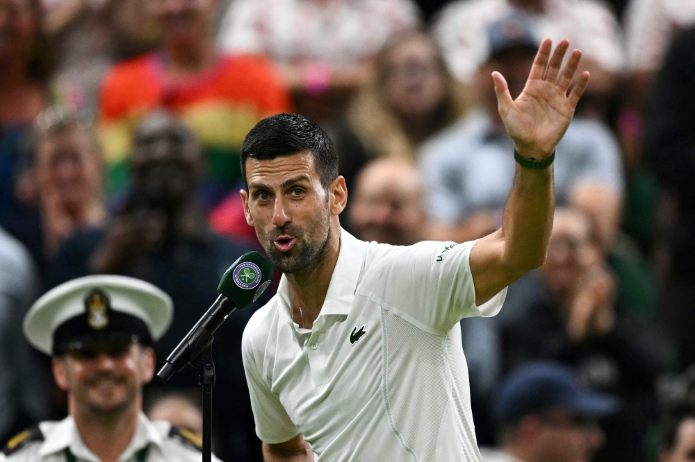 Winner Serbia's Novak Djokovic speaks during an interview and reacts to the cheering of the crowd at the end of his men's singles tennis match on July 8, 2024. (Photo by Ben Stansall / AFP) 