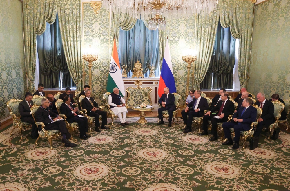 In this pool photograph distributed by the Russian state agency Sputnik, Russia's President Vladimir Putin meets with Indian Prime Minister Narendra Modi at the Kremlin in Moscow on July 9, 2024. (Photo by Sergei Karpukhin / POOL / AFP)