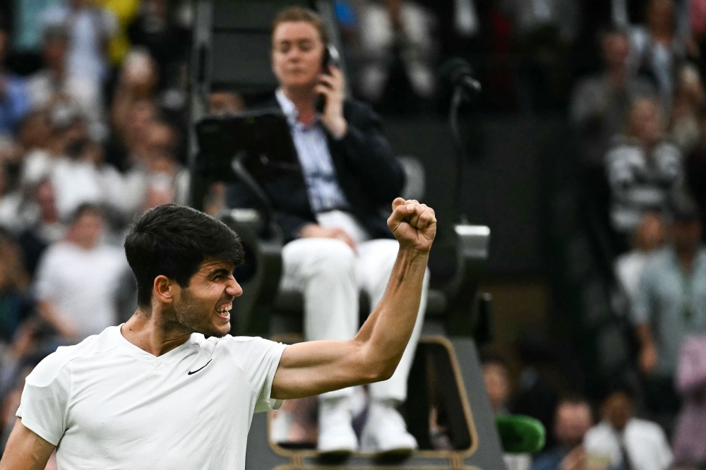 Spain's Carlos Alcaraz celebrates winning against USA's Tommy Paul during their men's singles quarter-finals tennis match on the ninth day of the 2024 Wimbledon Championships at The All England Lawn Tennis and Croquet Club in Wimbledon, southwest London, on July 9, 2024. (Photo by Ben Stansall / AFP)
