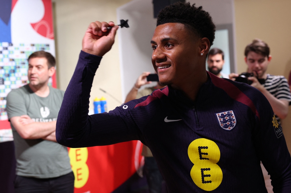 England's forward Ollie Watkins plays darts ahead of a press conference at the Weimarer Land Golf resort near Blankenhain on July 12, 2024. (Photo by Adrian DENNIS / AFP)
