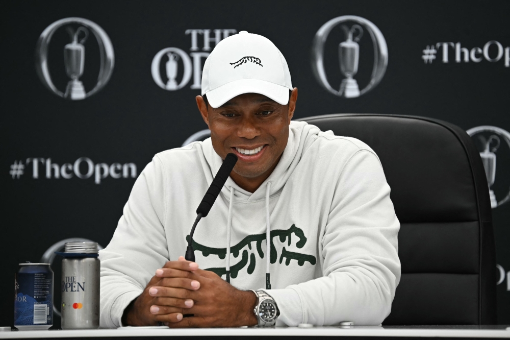 US golfer Tiger Woods smiles during a press conference held ahead of the 152nd British Open Golf Championship at Royal Troon on the south west coast of Scotland on July 16, 2024. (Photo by Paul ELLIS / AFP) / RESTRICTED TO EDITORIAL USE
