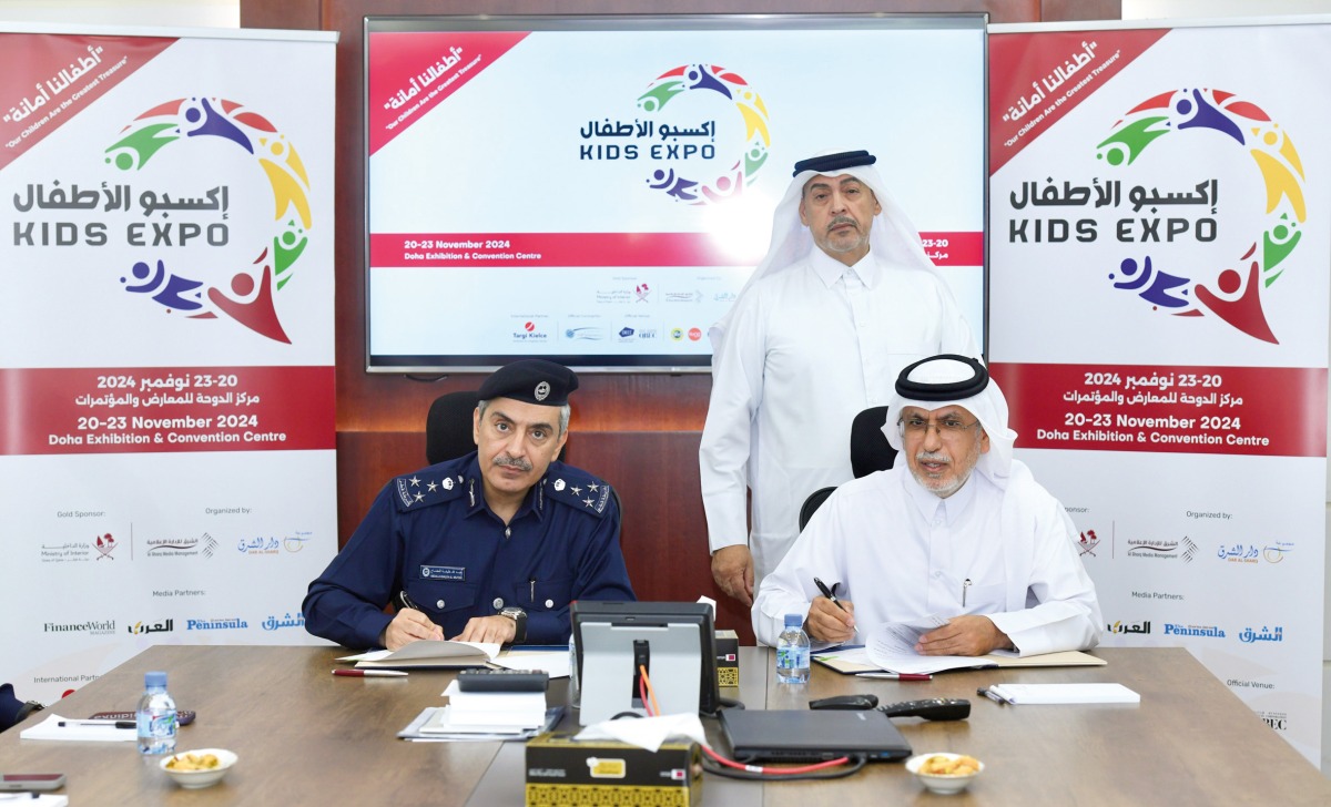 Deputy CEO of Dar Al Sharq Group  Jaber Al Harmi (right) and Director of Public Relations Department at the MoI, Brigadier General Abdullah Khalifa Salem Al Muftah (left) signing the agreement as Executive Director of Al Sharq Media Management and Executive Director of Kids Expo 2024, Eizeldin Abdulrahman, looks on.