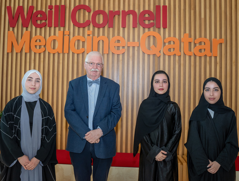 WCM-Q students Batoul Arabi (left), Shahad Sabaawi Ibrahim, and Raghad Sabaawi Ibrahim with Dr. Dietrich Büsselberg. 
