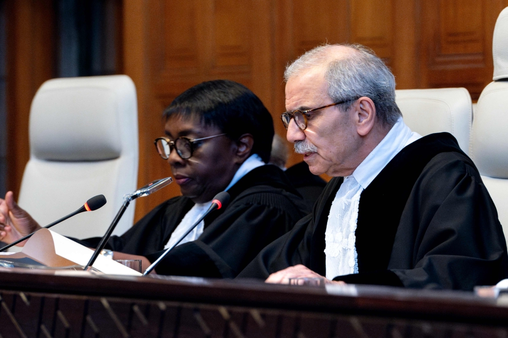 Judge and President of the International Court of Justice (ICJ), Nawaf Salam (R) delivers a non-binding ruling on the legal consequences of the Israeli occupation of the West Bank and East Jerusalem at the International Court of Justice (ICJ) in The Hague on July 19, 2024. (Photo by Nick Gammon / AFP)
