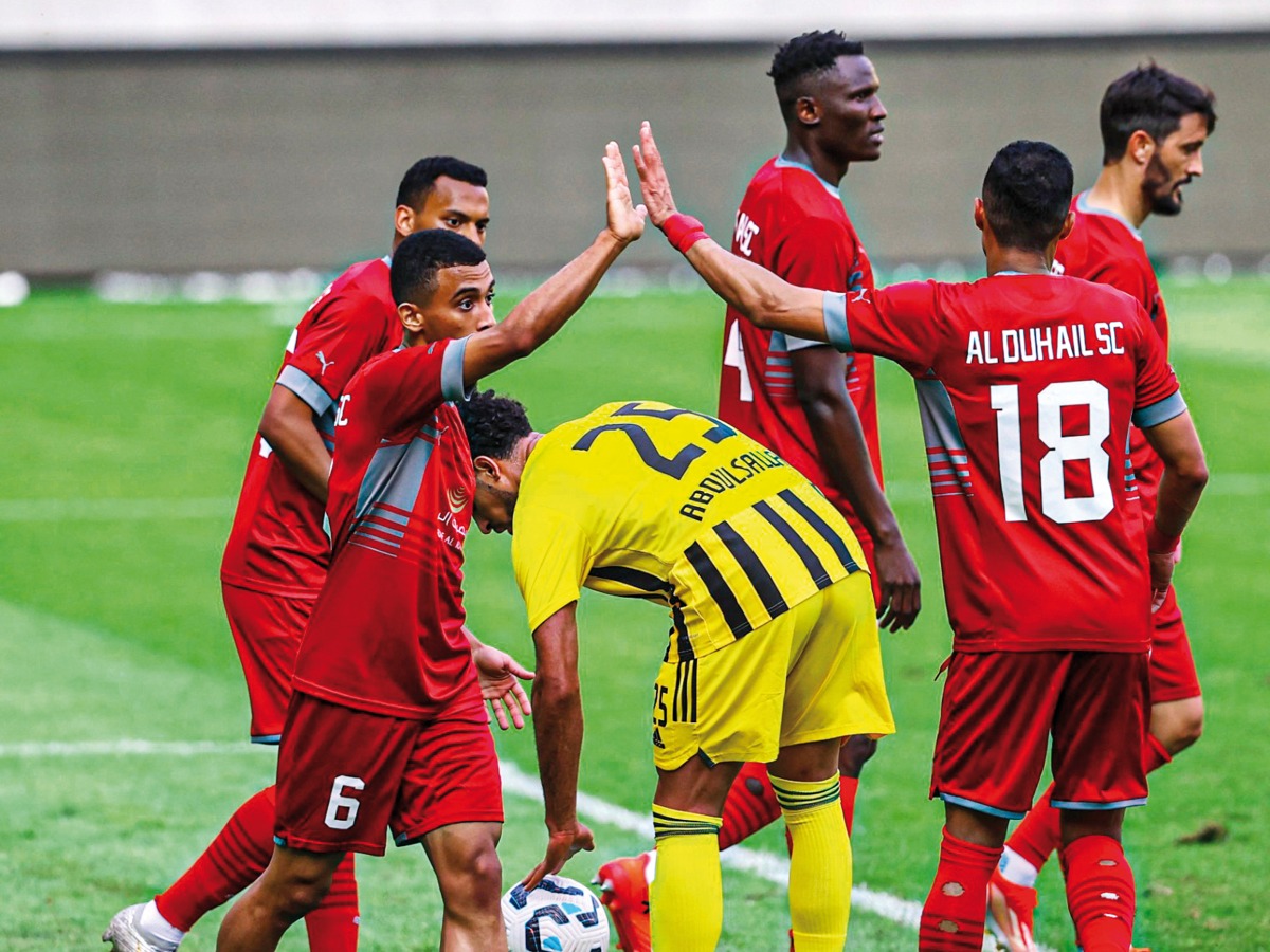 Al Duhail players celebrate after scoring a goal.