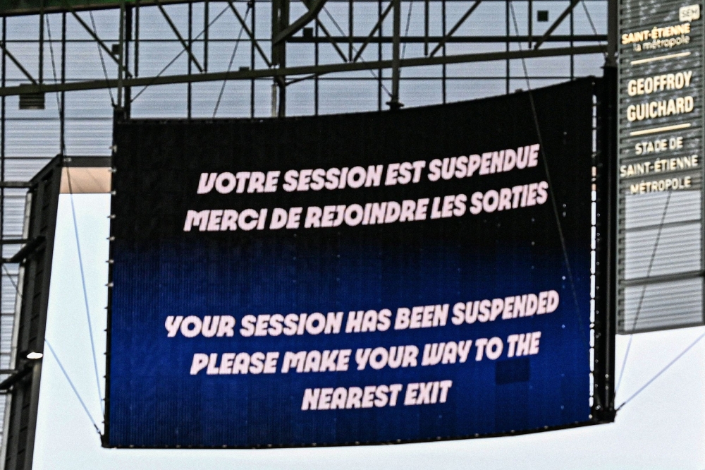 A giant screen informs about the match's interruption following incidents in the men's group B football match between Argentina and Morocco on July 24, 2024. (Photo by Arnaud Finistre / AFP)
 