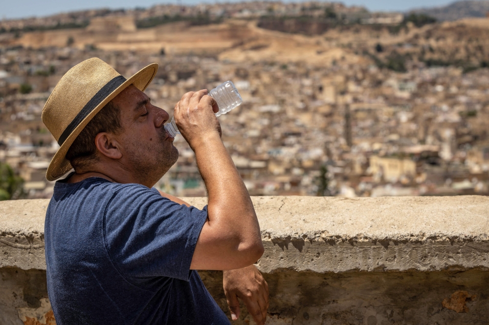 A man drinks water during during a heatwave in the city of Fez in Morocco on July 26, 2024. (Photo by Fadel Senna / AFP)

