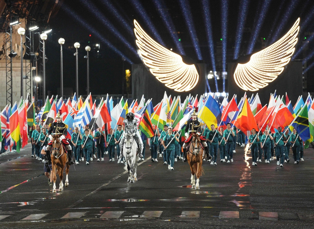 The horsewoman (C) arrive with the Olympic flag at the Trocadero Stadium during the opening ceremony of the Paris 2024 Olympic Games in Paris on July 26, 2024. (Photo by Xu Chang / POOL / AFP)
 