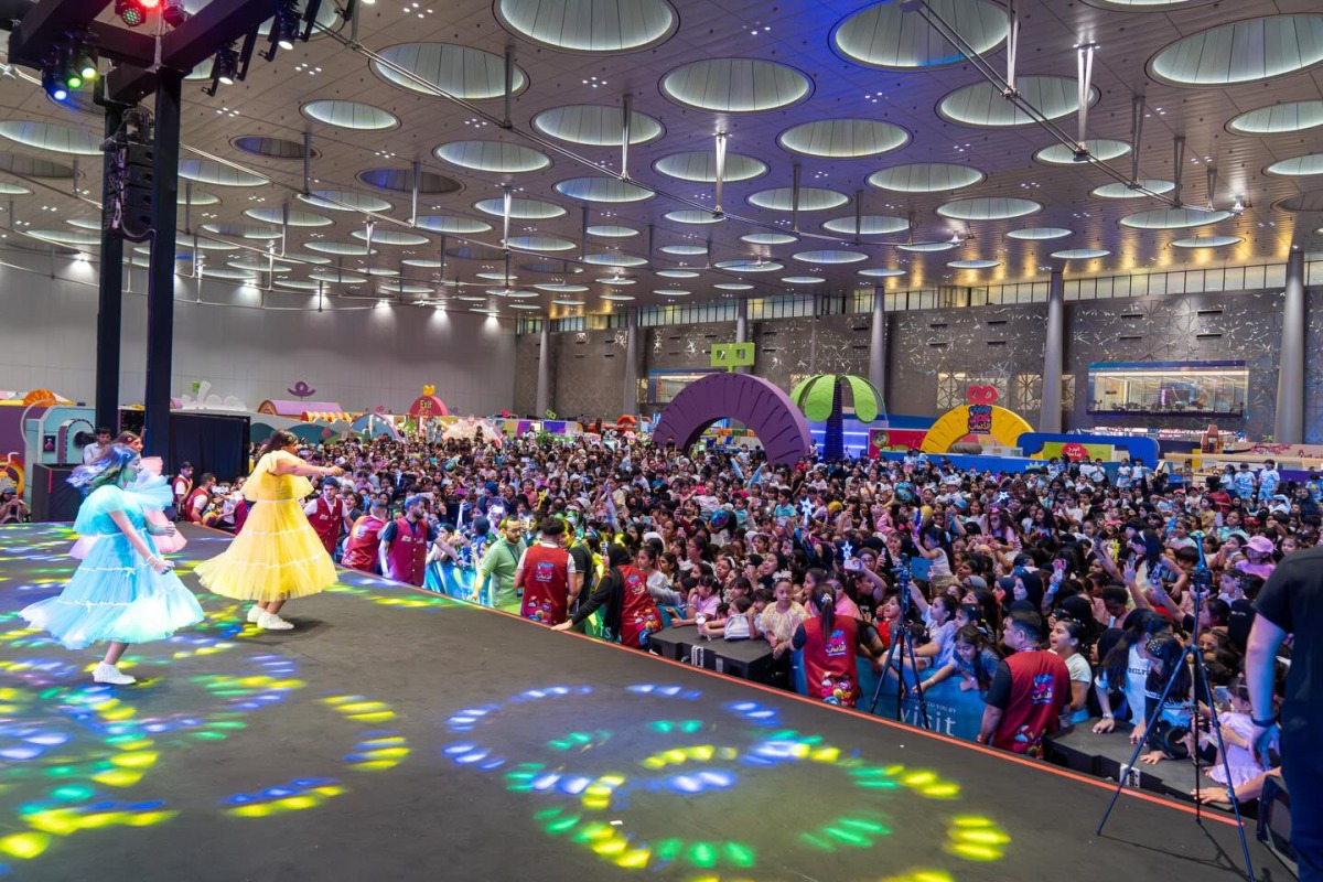 Children watch a performance at Qatar Toy Festival. 